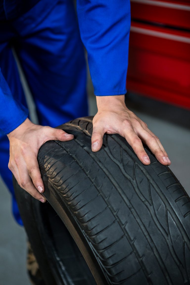 Mechanic pushing a tyre