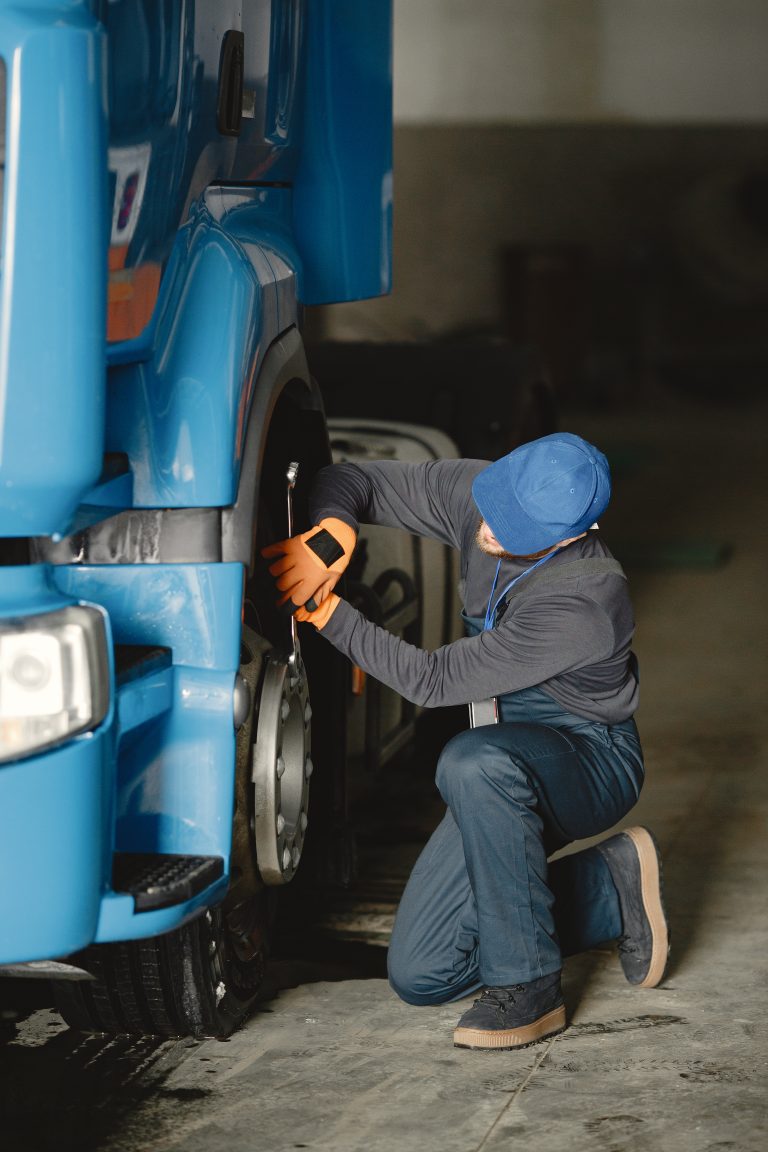 Worker checks quality of wheel in garage
